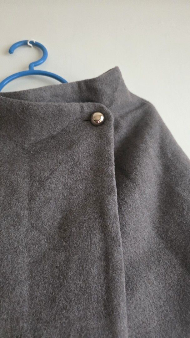 H&M Grey Mini Skirt (Category: Skirts) located in Las Pinas. Submitted by lovedbymariee (Listing ID 1468728402, Image 2). Description: - Brand: H&M - Item: Grey wool-like material mini skirt - Size: EUR 34 / US 2 / CA 2 / MX 2 / CN 160/64A - Details: Wrap-style front with single metallic button closure, fully lined for comfort - Condition: Great pre-loved condition - Style Tip: Versatile neutral piece, perfect for layering during cooler weather.