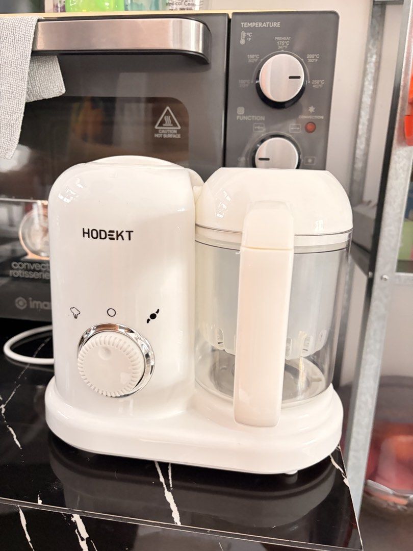 Hodekt Baby Food Maker Multi-function Blender Steamer (Category: Weaning & Toddler Feeding) located in Manila. Submitted by aubreyours07 (Listing ID 1468782315, Image 1). Description: - Brand: Hodekt Multi-Function Baby Food Maker - Color: Clean white, modern counter-top design - Features: 2-in-1 steaming and blending in one compact machine - Control: Easy-to-use front dial control - Jar: Clear jar with integrated handle for convenient handling -