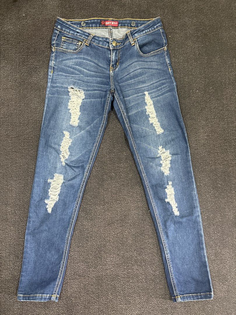 Hot Kiss Distressed Blue Denim Jeans (Category: Jeans) located in Quezon City. Submitted by fast.closetfinds (Listing ID 1468732964, Image 1). Description: - Brand: Hot Kiss - Style: Slim fit blue denim jeans with a medium wash - Details: Distressed knee and thigh rips, hip whiskering - Fit: Classic mid-rise waist with button closure and belt loops - Pockets: Functional front pockets - Condition: Great casual piece for everyday wear.