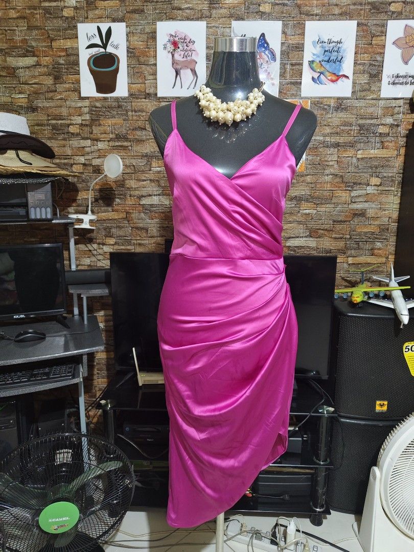 Hot Pink Satin Midi Dress (Category: Dresses) located in Manila. Submitted by duffy-080 (Listing ID 1468804653, Image 3). Description: - Color: Bright hot pink - Fabric: Smooth, silky satin with a slight shine - Straps: Adjustable spaghetti straps - Neckline: Crossover V-neck wrap-style bodice - Details: Flattering gathered ruching along the side and hip - Hem: Asymmetrical, falls below the knee - Closure: Back zipper - Condition: Clean and ready