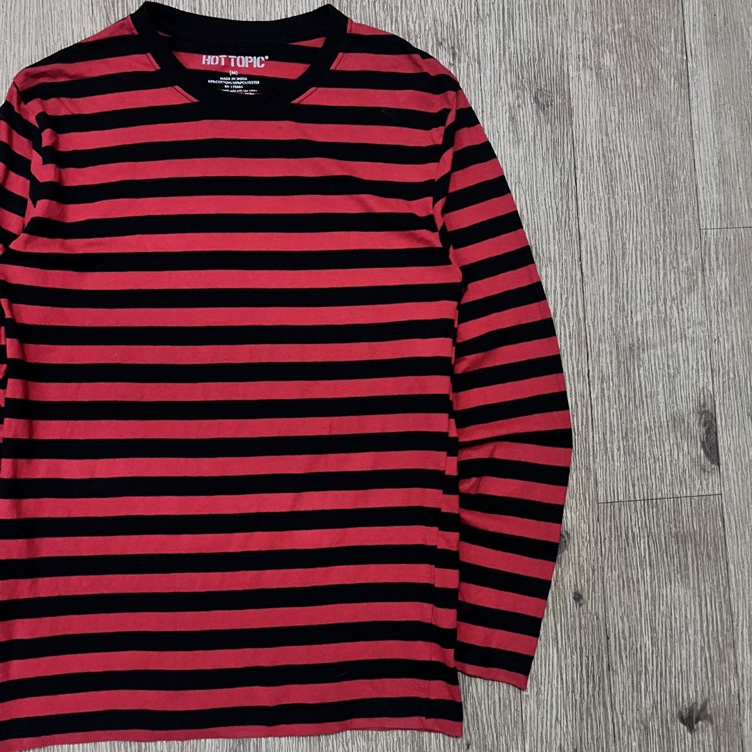 HOT TOPIC Red & Black Striped Long Sleeve (Category: Coats, Jackets and Outerwear) located in San Fernando. Submitted by curatedbyji_404 (Listing ID 1468722899, Image 3). Description: HOT TOPIC Red & Black Striped Long Sleeve Classic alt / emo / grunge staple piece. Maganda ang striped pattern at madaling iterno sa layered streetwear outfits. Brand: Hot Topic Color: Red / Black (Striped) Style: Long Sleeve Striped Shirt Size on Tag: Medium Fit: M