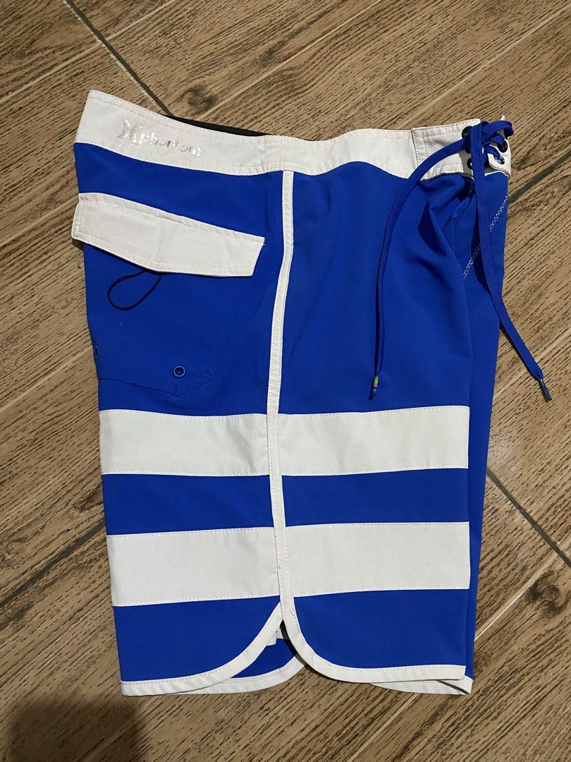 Hurley Phantom Boardshorts Blue White Size 30 (Category: Swim Trunks & Board Shorts) located in Binalbagan. Submitted by southsidethrift22 (Listing ID 1468837521, Image 2). Description: - Brand: Hurley Phantom - Size: Waist 30 - Color: Blue and White - Design: Striped pattern on left leg, Hurley logo patch on right - Features: Secure back pocket with flap, adjustable drawstring waistband - Material: Super lightweight, ideal for surfing and swimmi