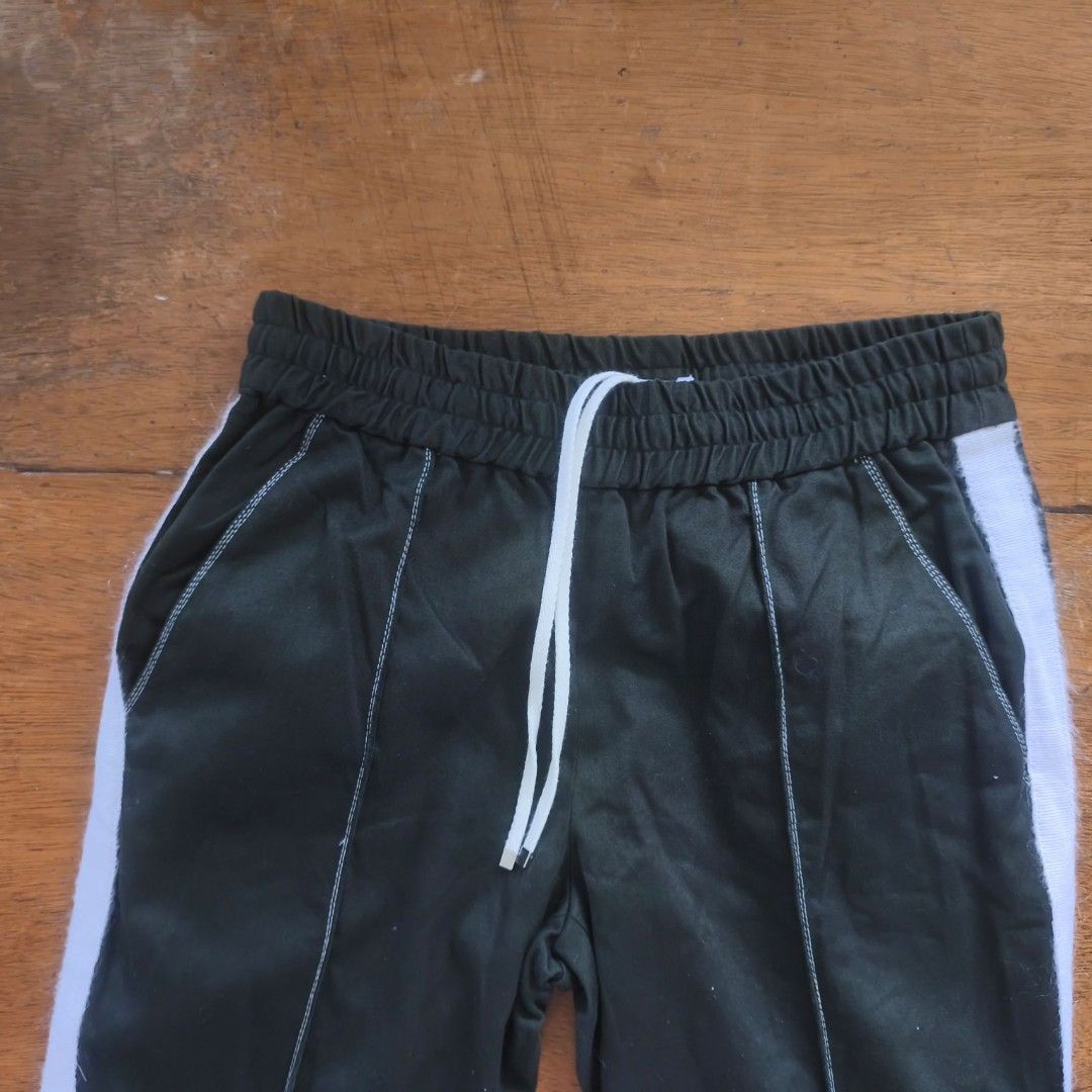 IHNN Japan track pants (Category: Luxury Apparel) located in Tayabas. Submitted by cat.b0i (Listing ID 1468822150, Image 2). Description: Size: 26-30 ‎rise: 10.5 ( mid Waisted) ‎hips: 37 ‎thighs: 11.5 ‎length: inseam: 29 ‎outseam : 40 ‎Hem: 9 ‎ ‎color: Army green with white ‎material: 100% cotton properties: Fraying on every hem because of extra fabric after stitching hardware: ‎issue: none, fraying is a natural effect ‎condition: excellent.