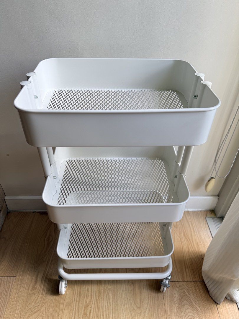 IKEA 3-Tier Rolling Utility Cart (Category: Shelves, Cabinets & Racks) located in Pasig City. Submitted by vdejesus (Listing ID 1468715215, Image 3). Description: 🛒 IKEA 3-Tier Rolling Utility Cart 📦 Product Details & Features: Design: 3-tier deep basket shelves with ventilated mesh bottoms Color: Clean Matte White Material: Durable Powder-Coated Steel / Metal Mobility: 4 Heavy-duty 360-degree swivel wheels (2 lockable wheels for stability) ✨ C
