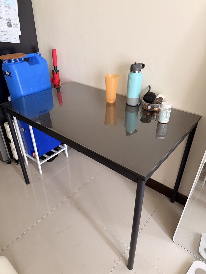 IKEA Sandsberg Table Black 110x67cm (Category: Tables & Sets) located in Mandaluyong City. Submitted by chekkamari (Listing ID 1468722335, Image 1). Description: 📍Mandaluyong Area - with Free PVC table cover - Brand: IKEA Sandsberg - Size: 110x67 cm - Material: Sturdy metal legs with dark wood-grain top - Condition: Clean, well-maintained, protected with a clear plastic cover sheet since day one - Design: Minimalist style, ideal for dining rooms