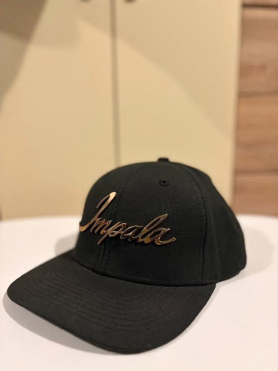 Impala Black Snapback Cap with Gold Metal Logo (Category: Vintage Collectibles) located in Cebu City. Submitted by ubecstoned (Listing ID 1468819506, Image 2). Description: - Color: Sleek black with a gold metallic script logo on the front - Fit: Adjustable plastic snapback strap for a custom fit - Design: Classic flat brim style - Details: Includes original inside branding and material tags.