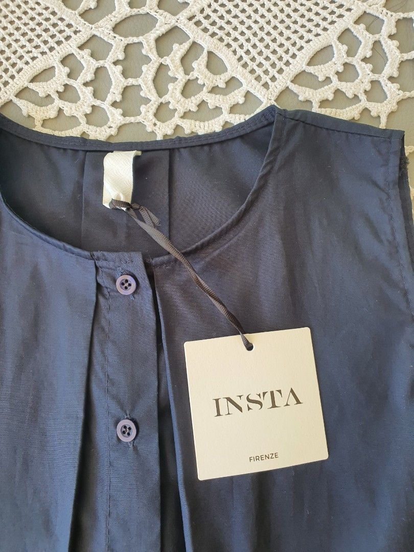 INSTA Firenze Navy Blue Sleeveless Button Top (Category: Sleeveless) located in Laoag. Submitted by soukay (Listing ID 1468719072, Image 3). Description: - Brand: INSTA Firenze from Italy - Color: Dark blue - Condition: Brand new with original paper tag attached, never worn - Style: Sleeveless top with round neckline, front button placket, matching round buttons, and pleated details - Size/Measurements: Roughly 21" across the chest and 22" in len