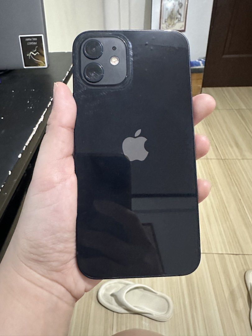 Iphone 12 (Category: iPhone 12 Series) located in Marikina City. Submitted by cheszam (Listing ID 1468842299, Image 3). Description: - Model: Apple iPhone 12 - Color: Black - Storage: 128GB - Condition: Excellent, well-maintained pre-owned unit - Display & Body: Clean screen and glossy back glass - Battery Health : 77%.