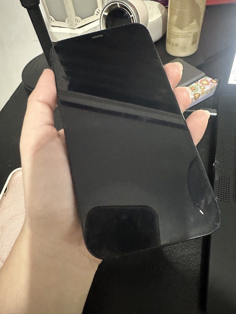 Iphone 12 (Category: iPhone 12 Series) located in Marikina City. Submitted by cheszam (Listing ID 1468842299, Image 2). Description: - Model: Apple iPhone 12 - Color: Black - Storage: 128GB - Condition: Excellent, well-maintained pre-owned unit - Display & Body: Clean screen and glossy back glass - Battery Health : 77%.