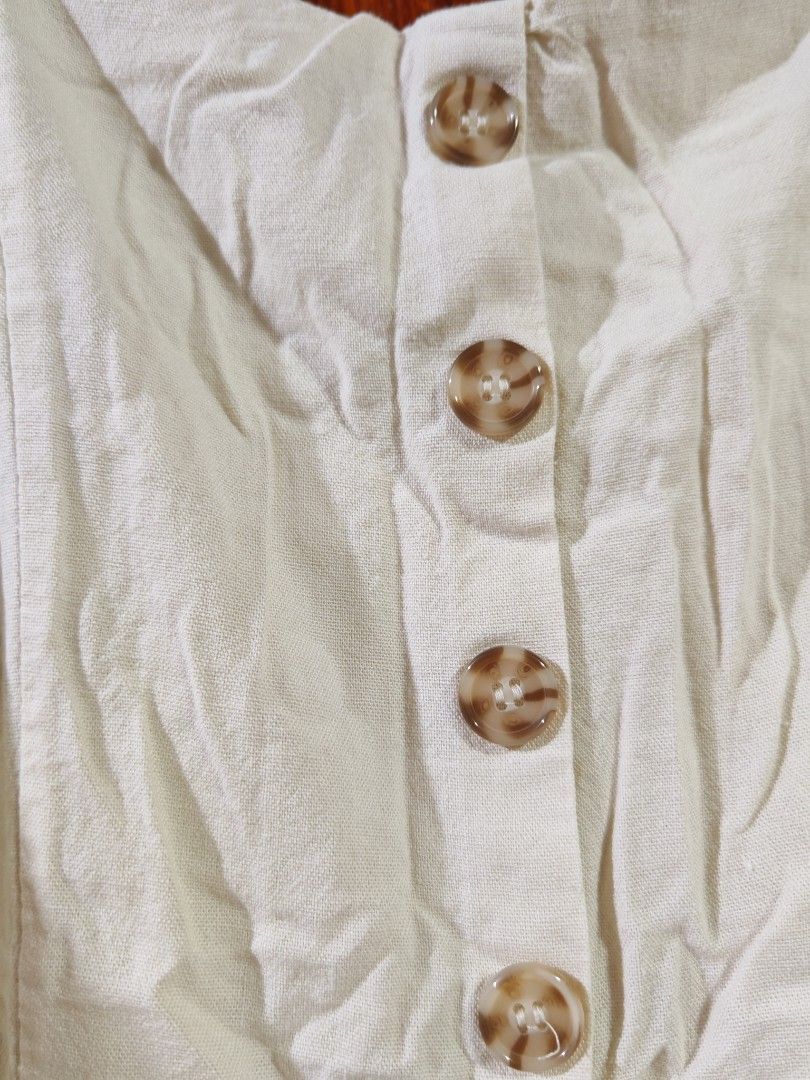 J Gee Cream Button-Front Jumpsuit Size XL (Category: Jumpsuits) located in Paranaque City. Submitted by MLandCobyApple (Listing ID 1468721674, Image 3). Description: - Brand: J Gee - Size: XL - Color: Cream - Style: Sleeveless wide-leg jumpsuit with button-front closure (four marbled brown buttons) - Comfort: Smocked elastic back panel for stretch and adjustable shoulder straps - Material: Lightweight fabric.