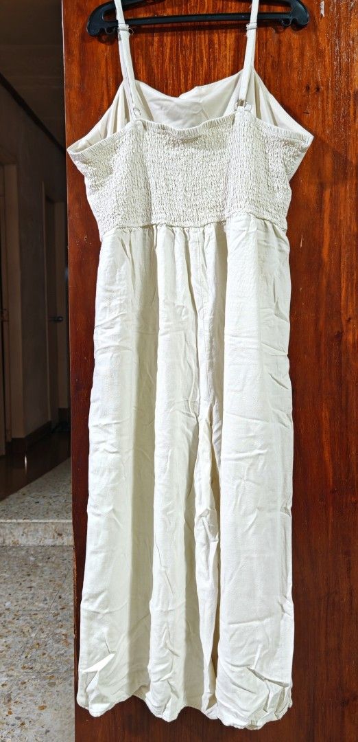 J Gee Cream Button-Front Jumpsuit Size XL (Category: Jumpsuits) located in Paranaque City. Submitted by MLandCobyApple (Listing ID 1468721674, Image 2). Description: - Brand: J Gee - Size: XL - Color: Cream - Style: Sleeveless wide-leg jumpsuit with button-front closure (four marbled brown buttons) - Comfort: Smocked elastic back panel for stretch and adjustable shoulder straps - Material: Lightweight fabric.