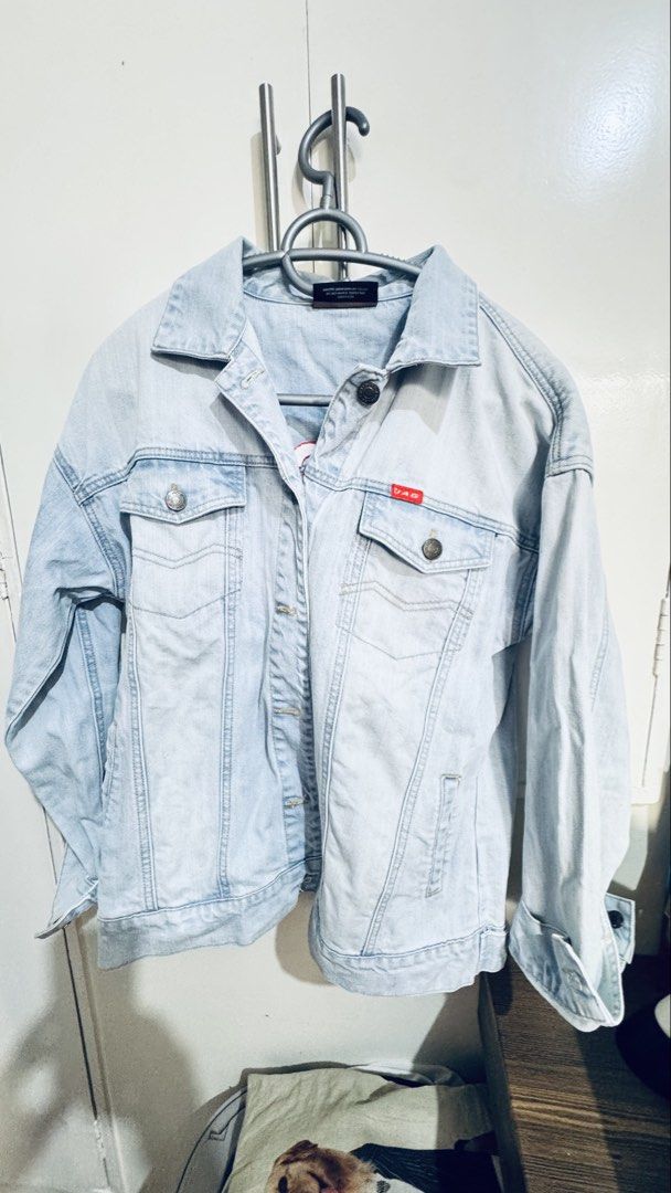Jag Jeans Light Wash Denim Jacket Size L (Category: Coats, Jackets and Outerwear) located in Manila. Submitted by silentcrystal-26f2 (Listing ID 1468771608, Image 3). Description: - Brand: Jag Jeans (Est. 1976) - Size: Large - Color/Wash: Light wash denim - Design: Classic trucker style with button-up front and chest pockets - Special Detail: Bold red JAG logo embroidery with a pink heart on the back and signature red brand tag - Fit: Easy to lay