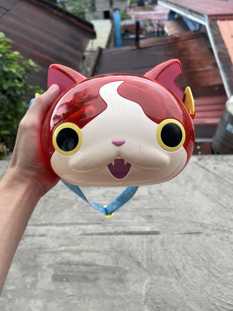 Jibanyan Yo-Kai Watch Popcorn Bucket (Category: Character Goods) located in Cavite. Submitted by vj_mp (Listing ID 1468766013, Image 1). Description: - Authentic Yo-Kai Watch Jibanyan collectible container - Red translucent dome back featuring iconic cat ears and yellow accents - Includes an attached blue strap with fun printed patterns - Perfect for fans and anime merchandise collectors - Condition: Brand new / Excellent (DM to inquire).