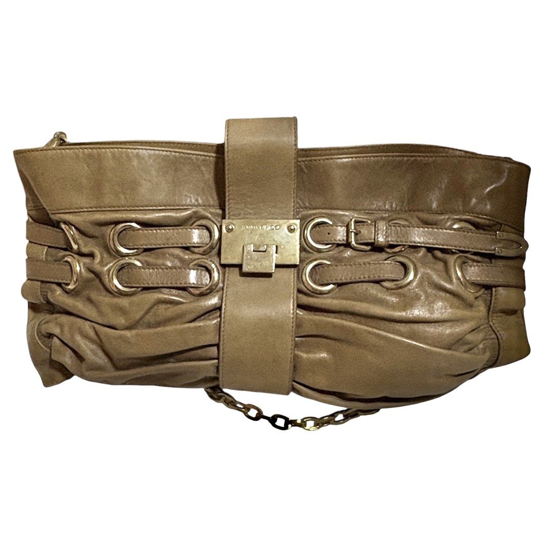 Jimmy Choo Taupe Leather Shoulder Bag (Category: Luxury Bags & Wallets) located in Los Banos. Submitted by amadea_c (Listing ID 1468752821, Image 1). Description: - Brand: Jimmy Choo - Material: Premium taupe leather - Hardware: Gold-tone with engraved logo plate - Closure: Center buckle strap - Strap: Black and gold-tone chain link - Interior: Fabric-lined with zippered pocket and brand plaque - Design: Spacious, slouchy everyday shoulder bag FO