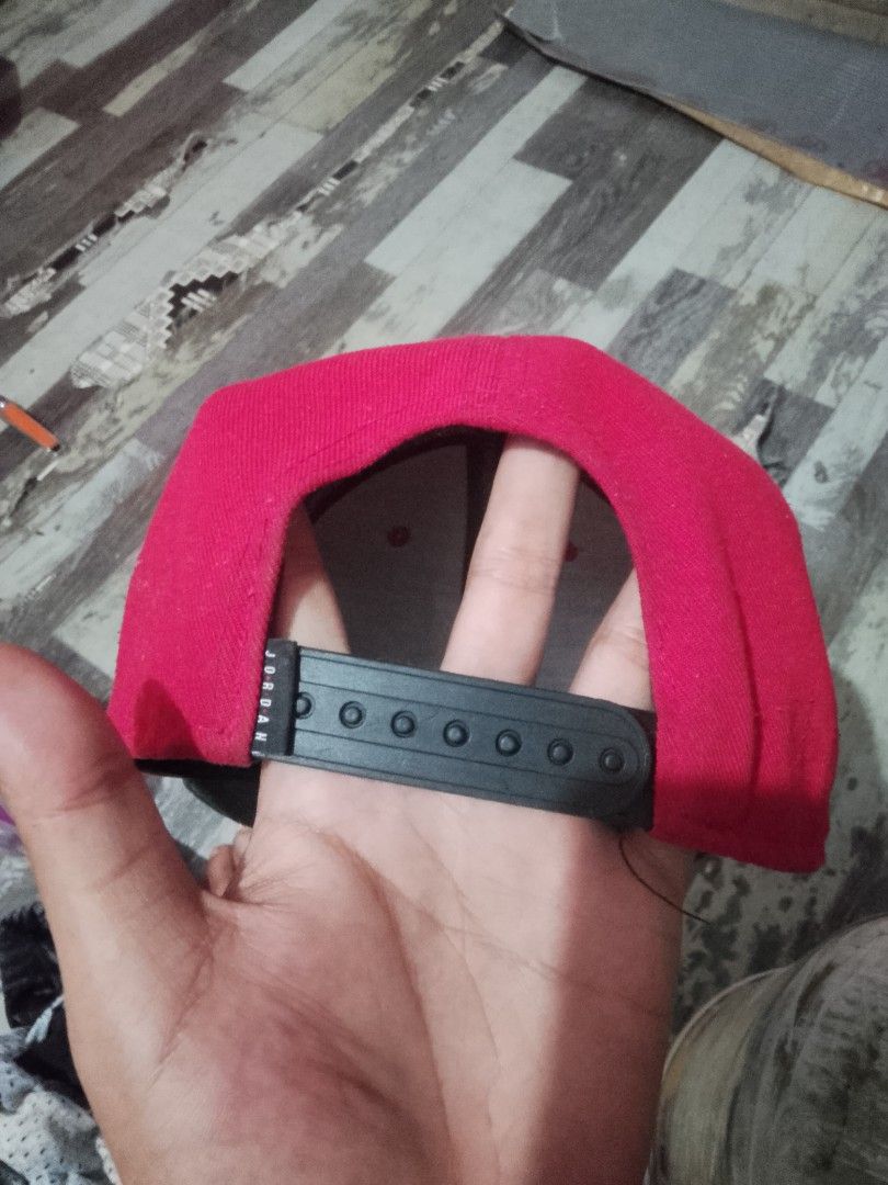 Jordan Jumpman Snapback Cap Red Black (Category: Caps & Hats) located in Quezon City. Submitted by theoneshop1 (Listing ID 1468892305, Image 2). Description: - Color: Red crown with a black flat brim - Branding: Embroidered Jumpman logo on the front and Jordan text on the snap - Fit: Adjustable plastic snap closure at the back - Details: Interior taped seams featuring 'Quality Inspired by the Greatest Player Ever' text - Material: 100% polyester 