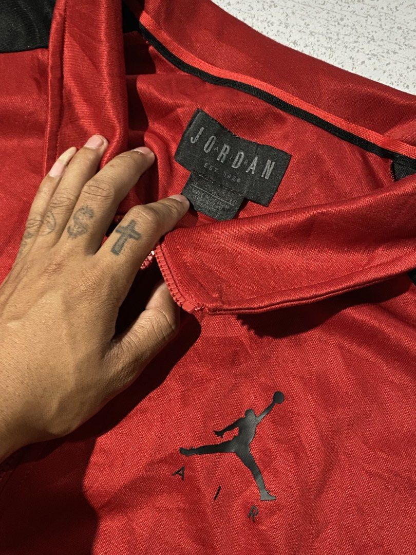 Jordan Red Black Track Jacket Size XL (Category: Coats, Jackets and Outerwear) located in Manila. Submitted by jeproxthrift (Listing ID 1468893241, Image 3). Description: - Brand: Jordan - Color: Red and black with white branding - Size: XL - Material: 100% polyester - Features: Zip-up front, side pockets, branded sleeve taping, and chest Jumpman logo - Origin: Made in Vietnam - Condition: Classic retro style, ready to wear.