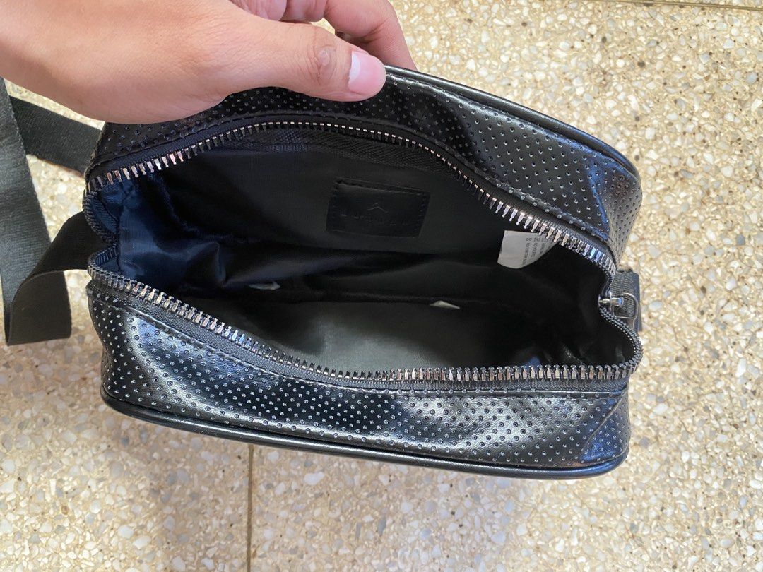 Jordan Sling Bag Black (Category: Sling Bags) located in Manila. Submitted by jamesyoungdope (Listing ID 1468836895, Image 2). Description: Sleek and versatile Nike Air Jordan Crossbody Bag in classic all-black. Featuring a perforated faux-leather body, iconic metallic Jumpman logo on the front upper trim, and a subtle “JORDAN” block lettering across the main body. Perfect for everyday use, travel, festivals, or casual street style..