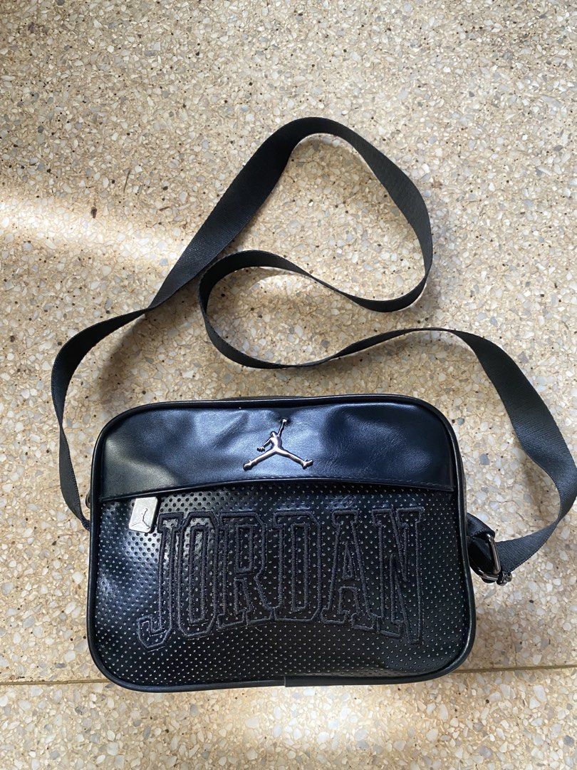 Jordan Sling Bag Black (Category: Sling Bags) located in Manila. Submitted by jamesyoungdope (Listing ID 1468836895, Image 1). Description: Sleek and versatile Nike Air Jordan Crossbody Bag in classic all-black. Featuring a perforated faux-leather body, iconic metallic Jumpman logo on the front upper trim, and a subtle “JORDAN” block lettering across the main body. Perfect for everyday use, travel, festivals, or casual street style..