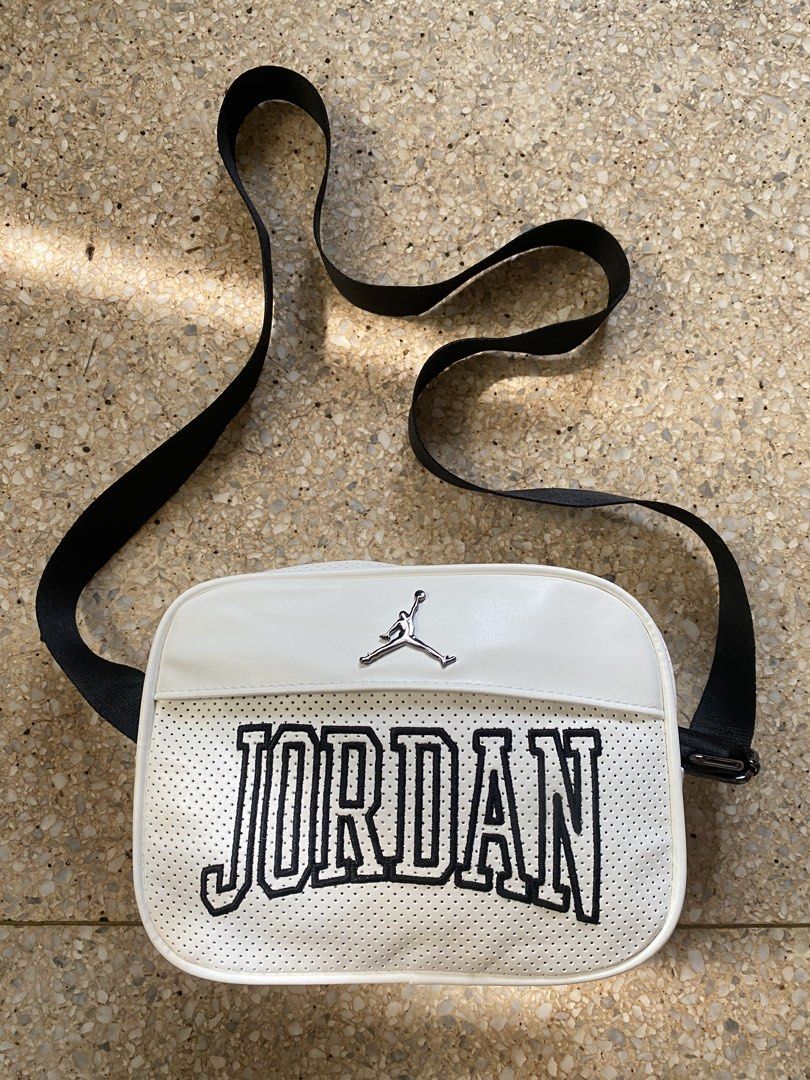 Jordan Sling Bag White (Category: Sling Bags) located in Manila. Submitted by jamesyoungdope (Listing ID 1468838698, Image 1). Description: Sleek and versatile Nike Air Jordan Crossbody Bag in classic all-white. Featuring a perforated faux-leather body, iconic metallic Jumpman logo on the front upper trim, and a subtle “JORDAN” block lettering across the main body. Perfect for everyday use, travel, festivals, or casual street style..