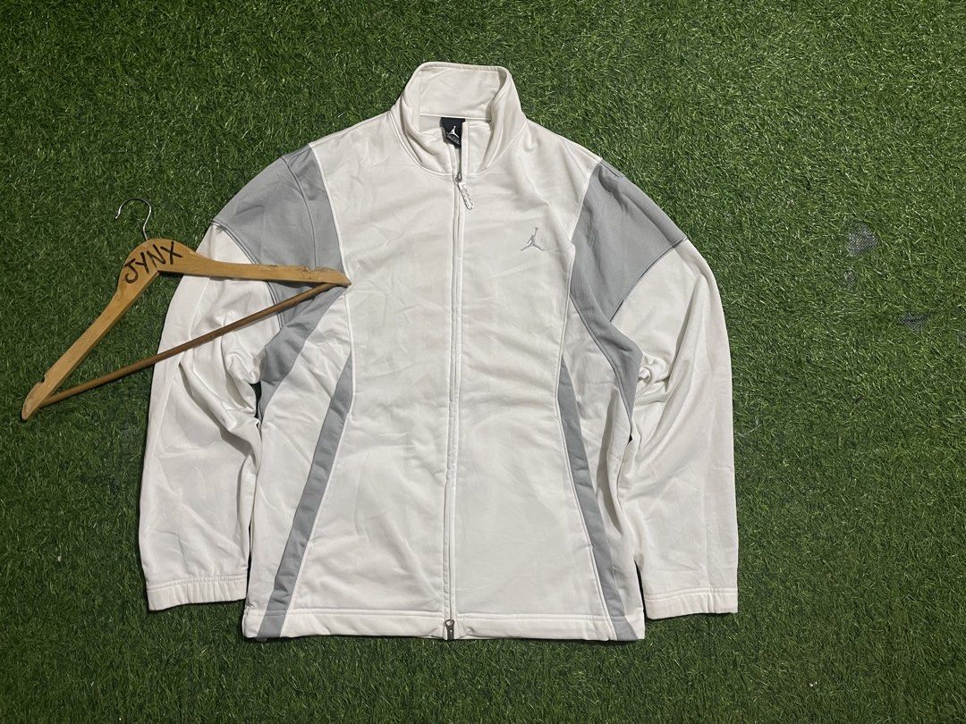 Jordan White and Grey Track Jacket Size S (Category: Coats, Jackets and Outerwear) located in Las Pinas. Submitted by jynxdefant26140 (Listing ID 1468900091, Image 1). Description: - Authentic Jordan track jacket - Color: White with grey panel accents - Size: Small - Made in Malaysia - Full zip closure with stand-up collar - Embroidered Jumpman logo on chest and small tag at hem - Ribbed cuffs for a comfortable fit - Condition: Excellent.