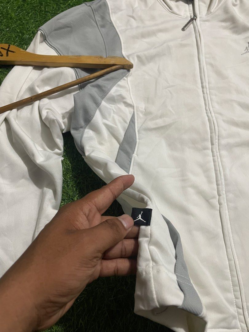 Jordan White and Grey Track Jacket Size S (Category: Coats, Jackets and Outerwear) located in Las Pinas. Submitted by jynxdefant26140 (Listing ID 1468900091, Image 3). Description: - Authentic Jordan track jacket - Color: White with grey panel accents - Size: Small - Made in Malaysia - Full zip closure with stand-up collar - Embroidered Jumpman logo on chest and small tag at hem - Ribbed cuffs for a comfortable fit - Condition: Excellent.