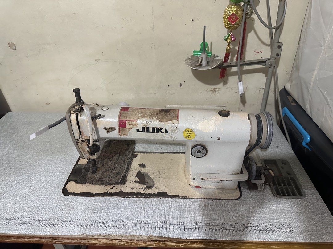 Juki Industrial Sewing Machine with Table and Motor (Category: Industrial Equipment) located in Pasay City. Submitted by kimverlygo50697 (Listing ID 1468792376, Image 3). Description: - Brand/Model: Juki heavy-duty industrial sewing machine - Setup: Mounted on a sturdy large wooden work table - Power: Integrated Asahi motor with foot pedal control and attached on/off switch box - Features: Built-in ruler along the table edge and spool holder stan