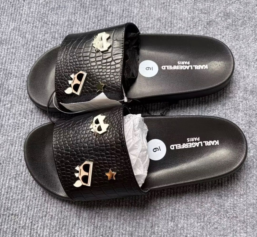 Karl Lagerfeld Paris Black Slides Sandals (Category: Flats & Sandals) located in Pasay City. Submitted by kgemsluxuryboutique (Listing ID 1468718681, Image 3). Description: - 100% Authentic Karl Lagerfeld Paris slides - Multiple stylish designs available: textured fabric, metallic accents, & classic logo prints - Super comfortable contoured footbed for all-day wear - Textured outsole provides reliable grip and anti-slip traction - Easy slip-on st
