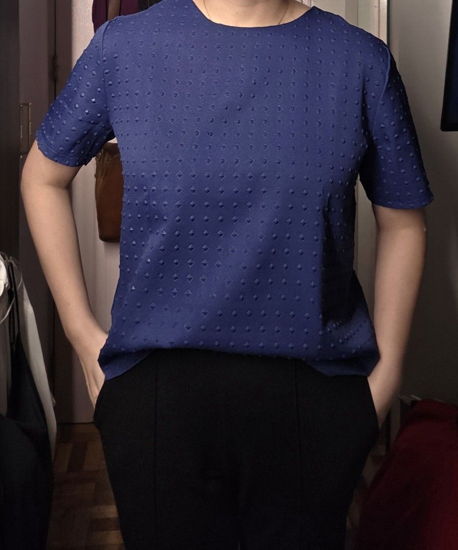Kashieca Blue Textured Short Sleeve Blouse Size L (Category: Blouses) located in Manila. Submitted by m.is.happy (Listing ID 1468886363, Image 1). Description: - Brand: Kashieca - Color: Navy Blue - Size: L - Neckline: Round neckline - Sleeves: Short sleeves - Closure: Back zip closure - Design: All-over geometric embossed square pattern - Material: Structured fabric that holds shape well - Condition: Clean condition inside and out.