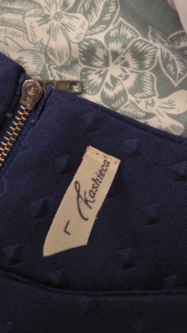 Kashieca Blue Textured Short Sleeve Blouse Size L (Category: Blouses) located in Manila. Submitted by m.is.happy (Listing ID 1468886363, Image 2). Description: - Brand: Kashieca - Color: Navy Blue - Size: L - Neckline: Round neckline - Sleeves: Short sleeves - Closure: Back zip closure - Design: All-over geometric embossed square pattern - Material: Structured fabric that holds shape well - Condition: Clean condition inside and out.