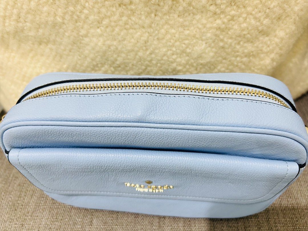 Kate Spade Camera Bag (Category: Cross-body Bags) located in Pasay City. Submitted by greenberry08 (Listing ID 1468923731, Image 3). Description: - Brand: Kate Spade New York - Material: Premium light blue pebbled leather - Closure: Smooth-zipping main compartment - Exterior: Front pocket with flap closure and metal logo lettering - Size: Compact and lightweight, ideal for daily essentials - Condition: Clean texture and excellent working zipper.