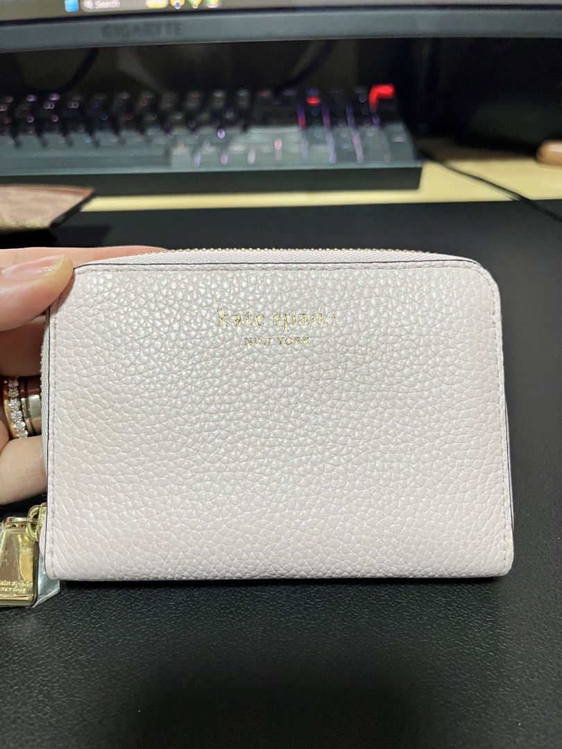 Kate Spade New York Pebble Leather Zip Wallet (Category: Wallets & Card holders) located in San Jose. Submitted by roxehfoxeh (Listing ID 1468801821, Image 1). Description: - Brand: Kate Spade New York - Color: Soft Pink - Material: Premium pebbled leather - Hardware: Elegant gold-tone with stamped front lettering - Closure: Secure top and side gold zipper - Condition: Brand new with tag still attached on zipper pull - Size: Compact and lightweig