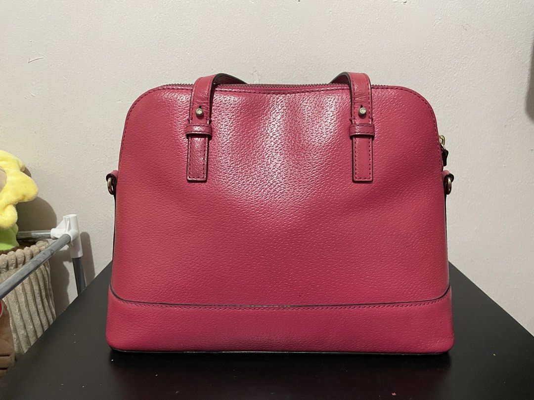 Kate Spade Pink Dome Satchel Handbag (Category: Luxury Bags & Wallets) located in Manila. Submitted by 6ollaa77 (Listing ID 1468773647, Image 2). Description: - Authentic Kate Spade dome satchel in vibrant bright pink pebble leather - Elegant gold foil logo stamped on the front - Double top handles with hardware attachments for an optional crossbody strap - Structured base panels to keep the bag standing upright easily - Secure zip top closure fo