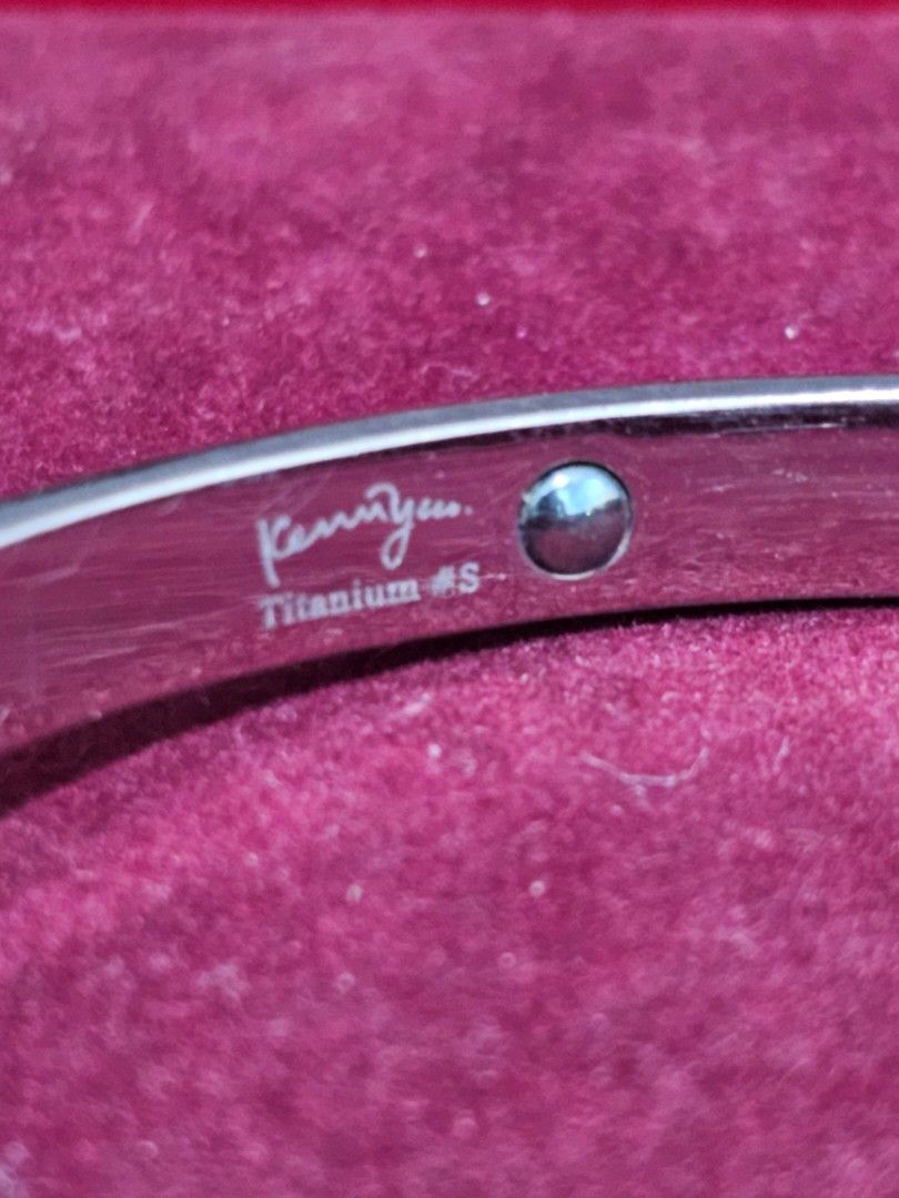Kenny & Co. Titanium Bracelet Bangle with Rhinestones (Category: Bracelets) located in Caloocan City. Submitted by smart_shoppers_ville (Listing ID 1468712697, Image 2). Description: Silver-colored screw motif bangle from Kenny & co. Titanium #S. Embedded with sparkling rhinestones alternating with screw head details. Hinged design with a secure clasp mechanism. Stamped on the inner band. Includes a red presentation box lined with velvet. Sturdy 