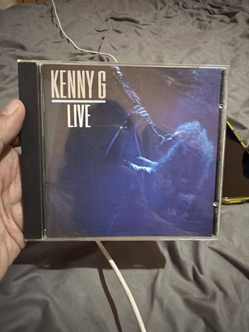 Kenny G Live CD Album (Category: CDs & DVDs) located in Tabaco. Submitted by cinemahilig (Listing ID 1468929285, Image 1). Description: - Artist & Title: Kenny G Live Audio CD - Format: Standard jewel case - Condition: Case has slight shelf wear, but the disc plays great - Genre: Classic smooth jazz - Perfect for jazz enthusiasts and CD collectors - Trusted Carousell seller with fast shipping.