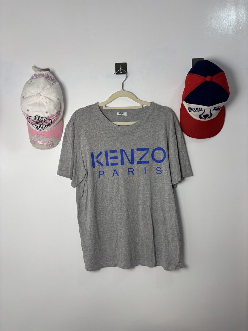 Kenzo Paris Grey T-Shirt (Category: Tshirts & Polo Shirts ) located in Calbayog City. Submitted by zaxcheus_castillo1708 (Listing ID 1468756666, Image 1). Description: - Brand: Kenzo Paris - Color: Grey with bold blue chest logo - Material: 100% Cotton - Fit: Regular fit, crew neck, short sleeves - Condition: Great everyday piece, easy to style with jeans or shorts - Fast shipping and reliable seller!.