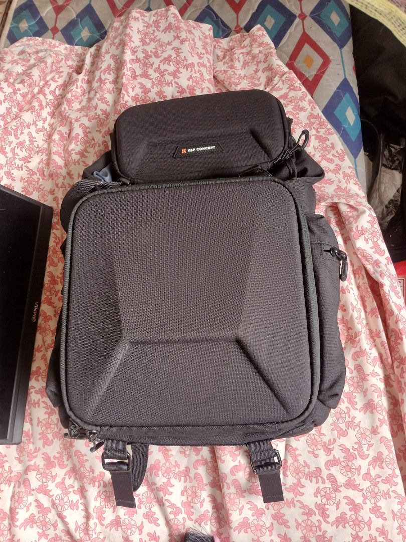 K&F Concept Camera Backpack Hard Shell Case (Category: Camera Bags & Carriers) located in Manila. Submitted by bonifacioc73501 (Listing ID 1468749954, Image 1). Description: - Brand: K&F Concept - Color: Black - Hard shell front design for maximum gear protection - Durable fabric construction with smooth-working zippers - Spacious interior designed for photography equipment - Includes attached side pouch with brand logo and multiple strap attachm