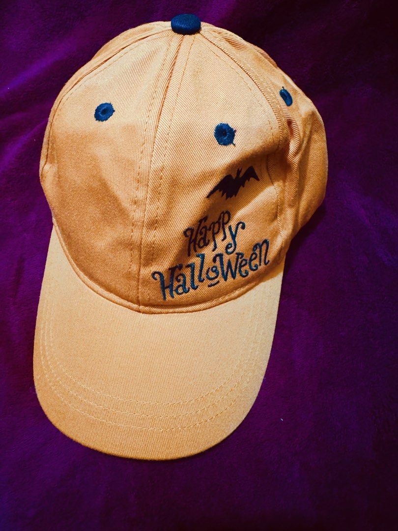 Kids Halloween Orange Cap (Category: Caps & Hats) located in La Trinidad. Submitted by whatnotcollections (Listing ID 1468890776, Image 1). Description: - Color: Vibrant orange. - Design: Embroidered "Happy Halloween" text and black bat graphic on the side front - Fit: Unstructured with an adjustable Velcro strap at the back - Condition: Brand new.