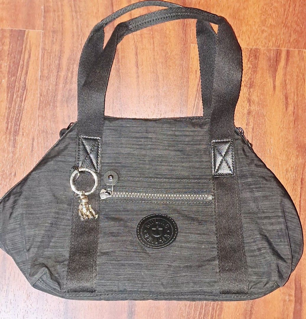 Kipling Black Nylon Tote Shoulder Bag with Strap (Category: Tote Bags) located in Baguio. Submitted by mng_assorted_baguio (Listing ID 1468787772, Image 1). Description: - Brand: Kipling - Material: Durable textured crinkle nylon in classic black - Carry options: Dual top handles and a detachable, adjustable shoulder strap - Pockets: Convenient front zip pocket with a spacious main compartment for daily essentials - Extras: Includes the iconic ro