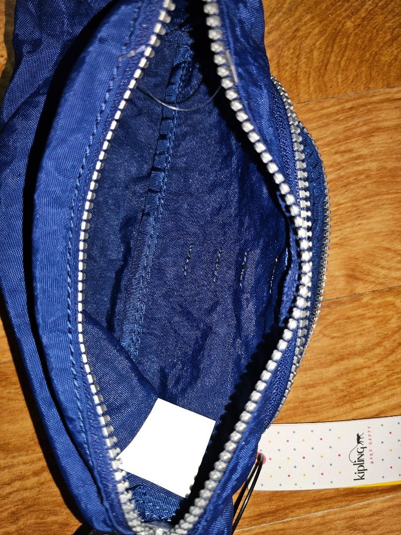 Kipling Blue Pouch Pencil Case (Category: Purses & Pouches) located in Quezon City. Submitted by findsbydavie (Listing ID 1468821695, Image 3). Description: - Brand: Kipling - Condition: Brand new with tags attached - Color: Deep blue with iconic round logo patch - Material: Durable textured nylon - Features: Multiple zippered compartments and built-in elastic pen holders - Details: Branded zipper pulls - Perfect for: Organizing stationery, makeu