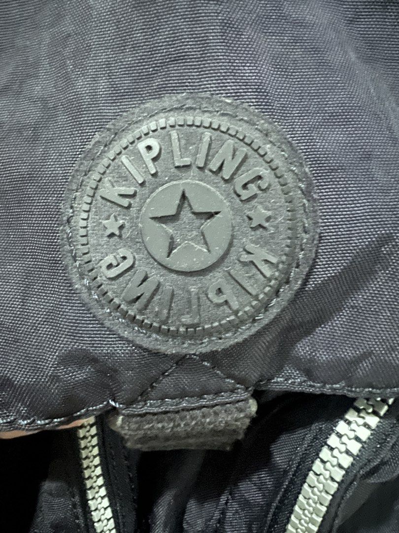 Kipling Navy Blue Nylon Backpack (Category: Backpacks) located in San Fernando. Submitted by WonderMamaonlineshop (Listing ID 1468892151, Image 2). Description: - Brand: Kipling - Color: Dark navy blue - Material: Nylon - Features: Front buckle, 2 front zip pockets with circular branded pull tabs, top handle, and adjustable shoulder straps - Condition: Excellent / Ready to use - Perfect for daily commute, school, or travel.