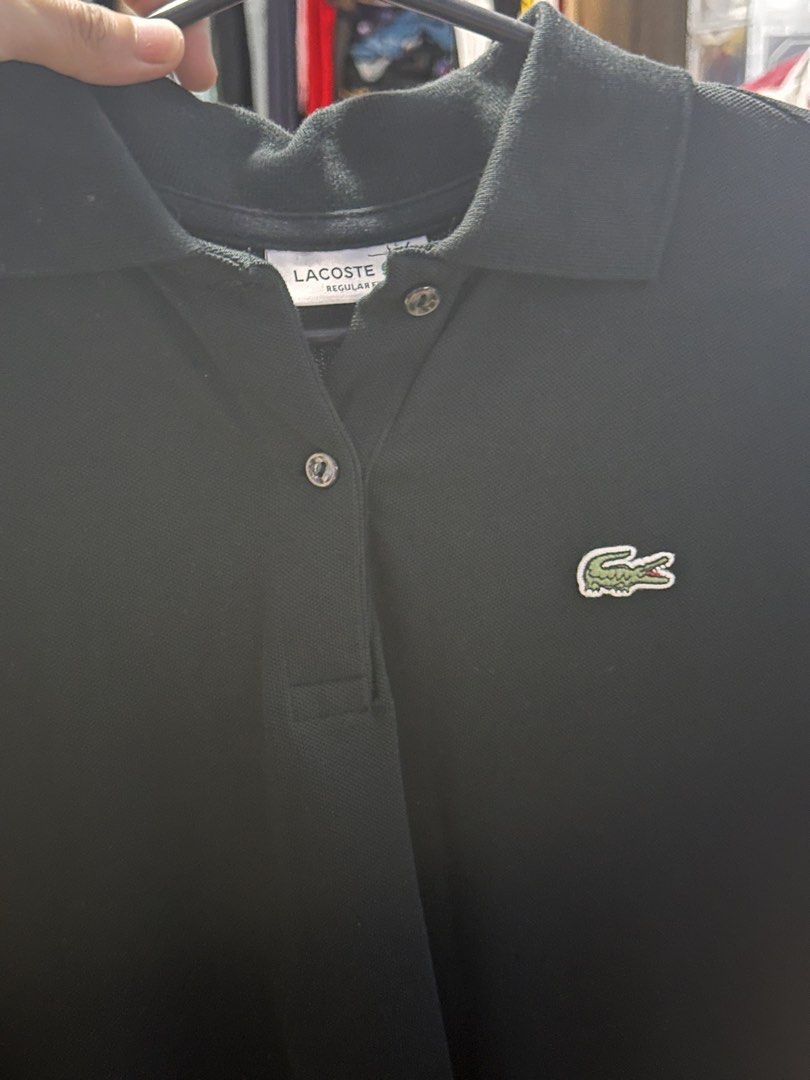 Lacoste Black Regular Fit Polo Shirt (Category: Tshirts & Polo Shirts ) located in Las Pinas. Submitted by boldbear_89ab40 (Listing ID 1468854411, Image 2). Description: - Brand: Lacoste - Color: Black - Fit: Regular fit - Material: Comfortable cotton pique fabric - Design: Classic style with embroidered crocodile logo and standard button placket - Versatility: Easy to pair with jeans or chinos for casual wear.