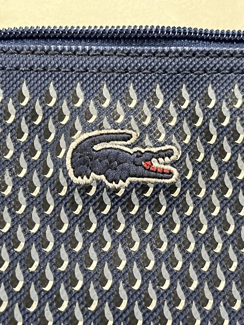 Lacoste Blue Patterned Tote Bag (Category: Tote Bags) located in Quezon City. Submitted by akismurabels (Listing ID 1468764616, Image 2). Description: AUTHENTIC Decluterring my personal items Size: L:39cm W: 15cm H:34cm Loc: Quezon City MOP: Gcash MOD: Lalamove PM if interested Slightly negotiable - Brand: Lacoste - Color: Classic Navy Blue - Material/Design: Unique textured exterior pattern with a clean, structured base - Straps: Comfortable thi