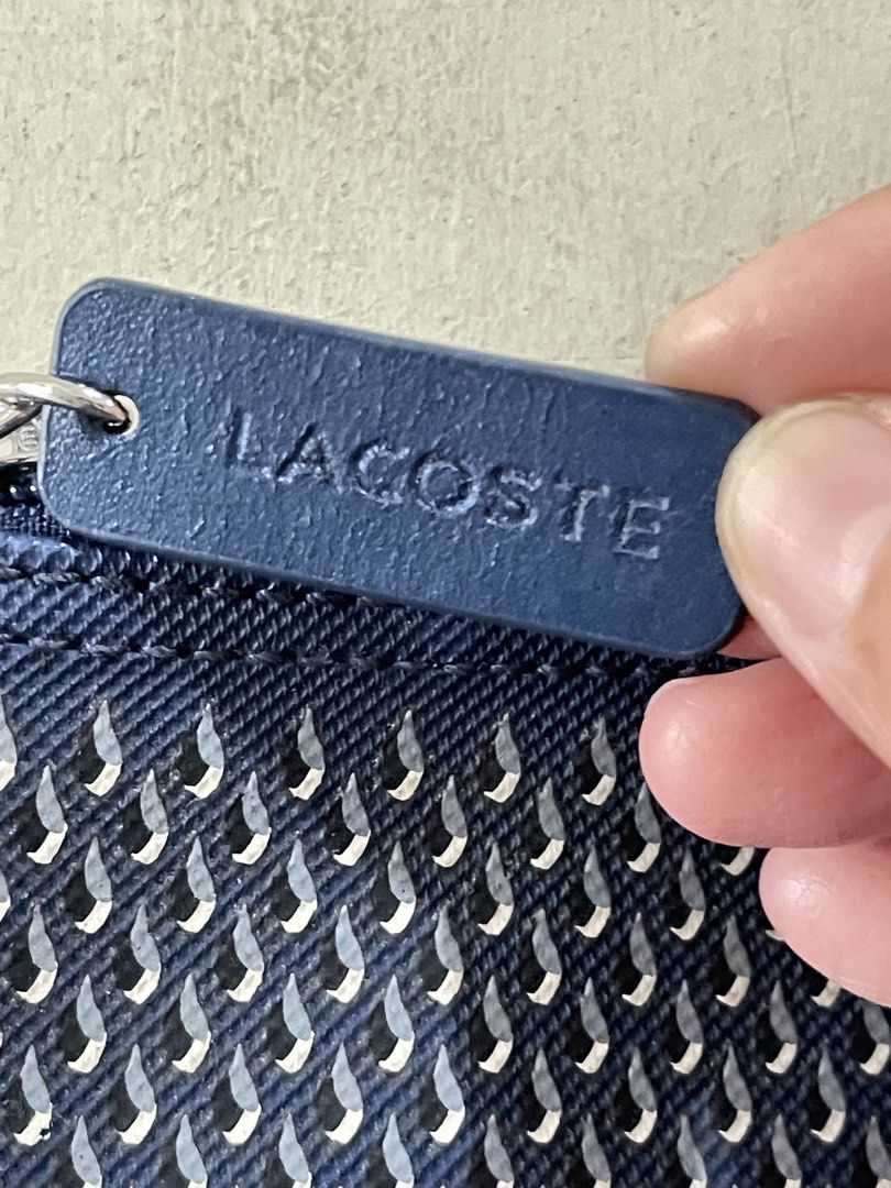 Lacoste Blue Patterned Tote Bag (Category: Tote Bags) located in Quezon City. Submitted by akismurabels (Listing ID 1468764616, Image 3). Description: AUTHENTIC Decluterring my personal items Size: L:39cm W: 15cm H:34cm Loc: Quezon City MOP: Gcash MOD: Lalamove PM if interested Slightly negotiable - Brand: Lacoste - Color: Classic Navy Blue - Material/Design: Unique textured exterior pattern with a clean, structured base - Straps: Comfortable thi