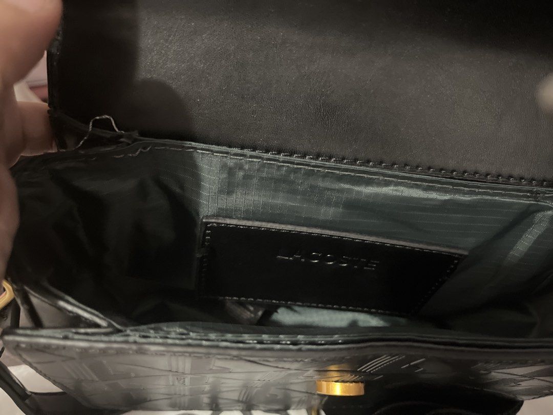 Lacoste Campanula Black Crossbody Bag (Category: Cross-body Bags) located in Pasig City. Submitted by melaiski28 (Listing ID 1468763102, Image 3). Description: Black Lacoste Campanula Crossbody Bag - Material: Durable PVC and polyurethane split cow leather - Design: Stylish all-over geometric embossed pattern with gold-tone hardware - Interior: Premium fabric lining with a convenient branded slip pocket - Strap: Adjustable black strap for a custo