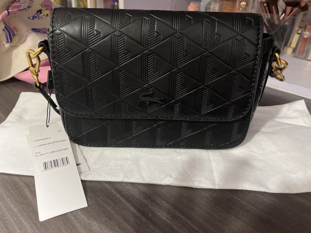 Lacoste Campanula Black Crossbody Bag (Category: Cross-body Bags) located in Pasig City. Submitted by melaiski28 (Listing ID 1468763102, Image 1). Description: Black Lacoste Campanula Crossbody Bag - Material: Durable PVC and polyurethane split cow leather - Design: Stylish all-over geometric embossed pattern with gold-tone hardware - Interior: Premium fabric lining with a convenient branded slip pocket - Strap: Adjustable black strap for a custo