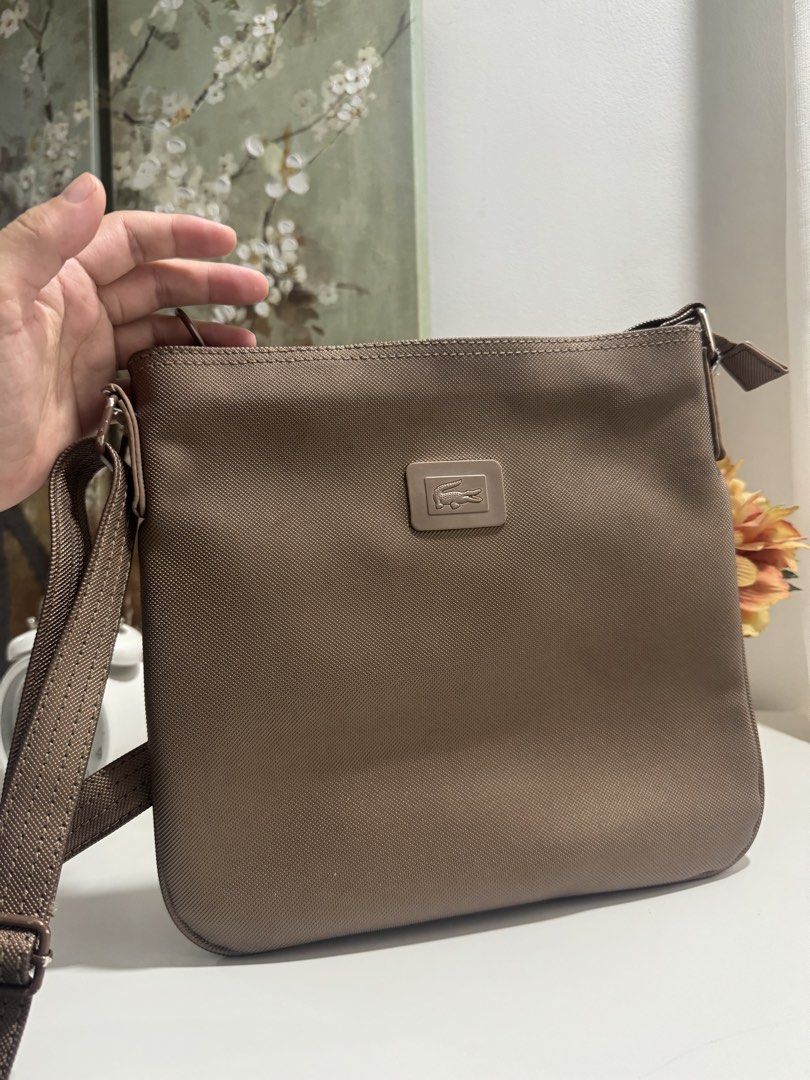 Lacoste Crossbody Bag (Category: Cross-body Bags) located in Manila. Submitted by prelovemd (Listing ID 1468712750, Image 1). Description: Authentic lacoste Bought in US Color bronze-gold Take note of stains inside the bags Barely noticeable minor scratches on external Zippers working well .