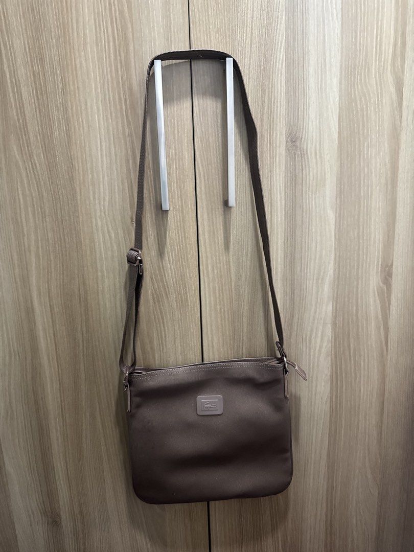 Lacoste Crossbody Bag (Category: Cross-body Bags) located in Manila. Submitted by prelovemd (Listing ID 1468712750, Image 3). Description: Authentic lacoste Bought in US Color bronze-gold Take note of stains inside the bags Barely noticeable minor scratches on external Zippers working well .