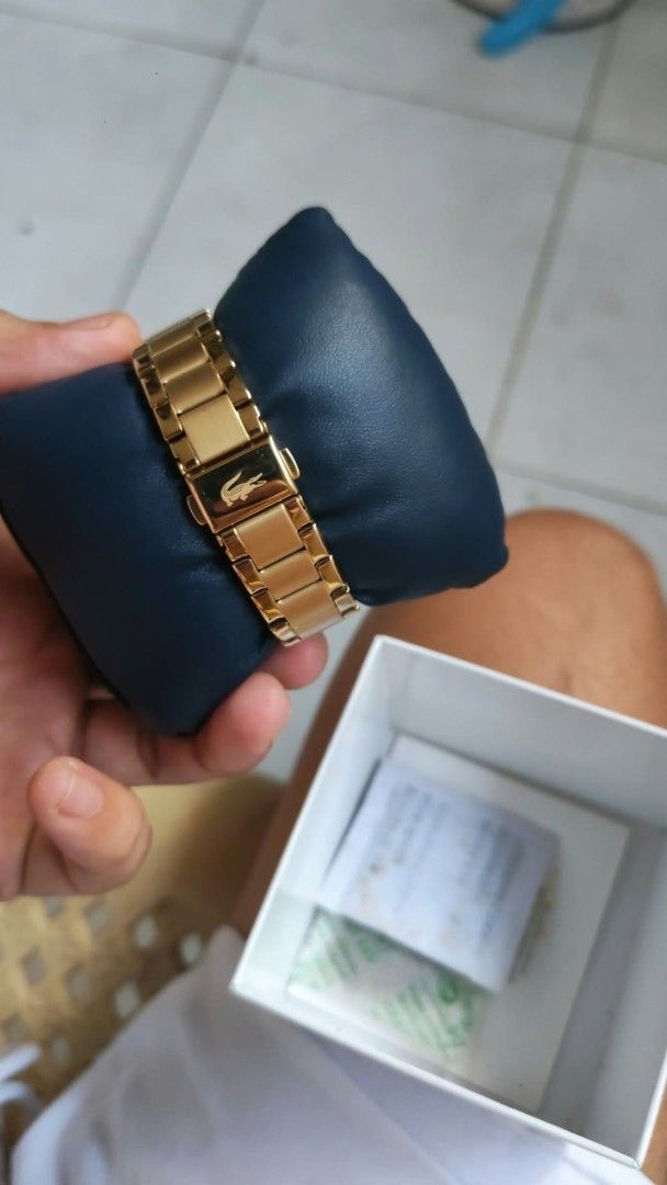 Lacoste Gold Watch with Black Dial (Category: Luxury Watches) located in Luisiana. Submitted by sahayamay77 (Listing ID 1468776865, Image 2). Description: - Brand: Lacoste - Color: Elegant gold-tone with a clean black dial - Material: Durable gold stainless steel bracelet band with clasp closure - Design: Features a stylish textured bezel and the iconic Lacoste crocodile logo - Inclusions: Comes with the original Lacoste presentation box - Condit
