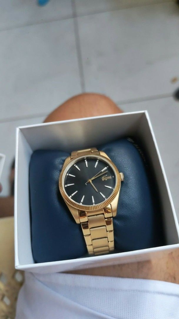 Lacoste Gold Watch with Black Dial (Category: Luxury Watches) located in Luisiana. Submitted by sahayamay77 (Listing ID 1468776865, Image 1). Description: - Brand: Lacoste - Color: Elegant gold-tone with a clean black dial - Material: Durable gold stainless steel bracelet band with clasp closure - Design: Features a stylish textured bezel and the iconic Lacoste crocodile logo - Inclusions: Comes with the original Lacoste presentation box - Condit