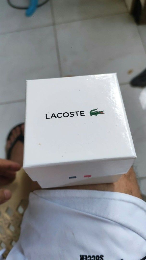 Lacoste Gold Watch with Black Dial (Category: Luxury Watches) located in Luisiana. Submitted by sahayamay77 (Listing ID 1468776865, Image 3). Description: - Brand: Lacoste - Color: Elegant gold-tone with a clean black dial - Material: Durable gold stainless steel bracelet band with clasp closure - Design: Features a stylish textured bezel and the iconic Lacoste crocodile logo - Inclusions: Comes with the original Lacoste presentation box - Condit